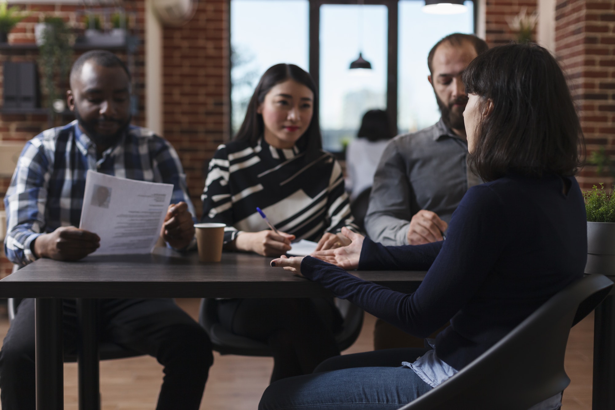 Startup company recruitment board reviewing CV resume of job candidate during interview process in